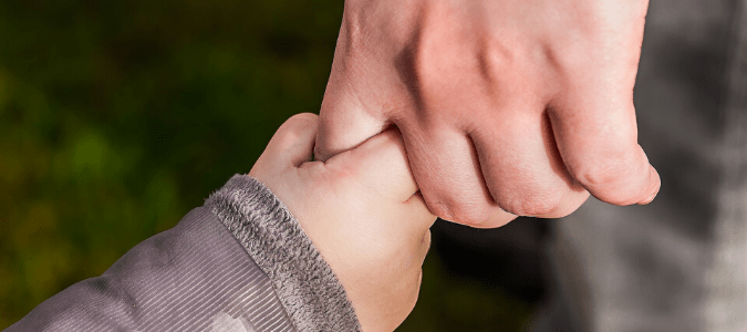 A father and daughter holding hands