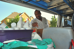 Pest control specialist reviewing supplies in truck